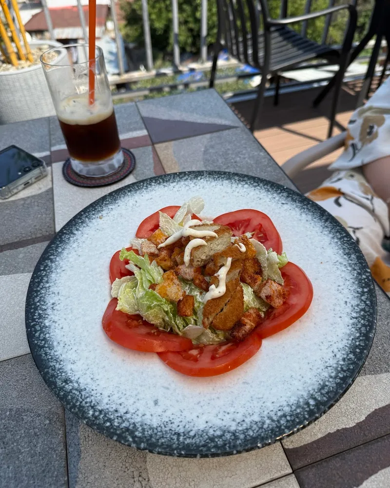 Salad with sliced tomatoes and fried nuggets at Livin & Jagannath