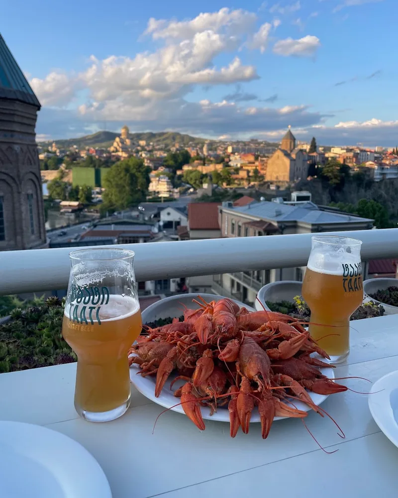 Boiled crayfish with glasses of craft beer at Los Crayfish Hermanos
