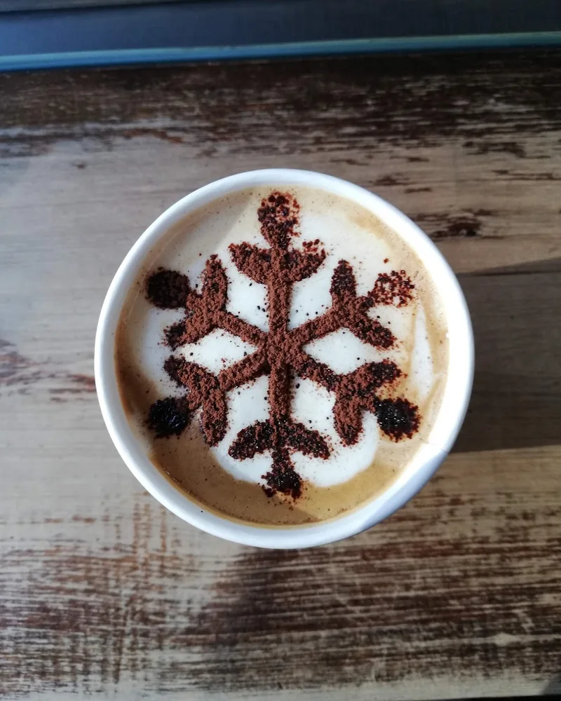Latte with cocoa powder snowflake stencil at Luca Polare