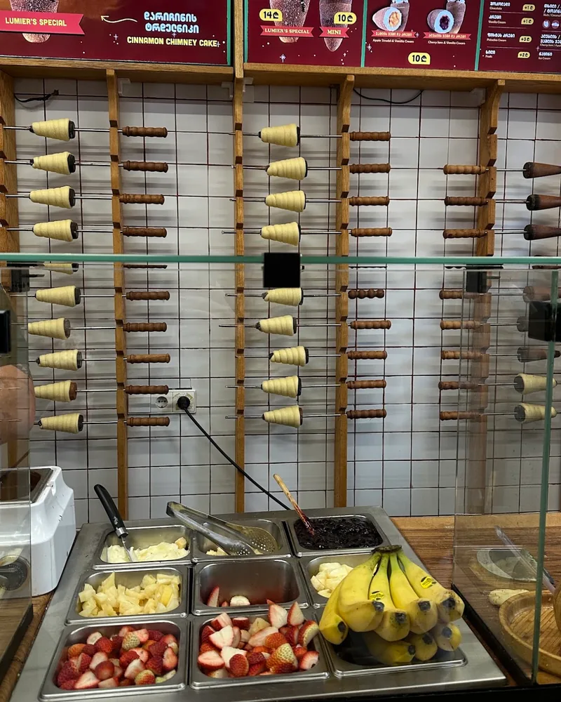 Chimney cake spindles and fruit toppings at the counter of Lumier’s Chimney Cake