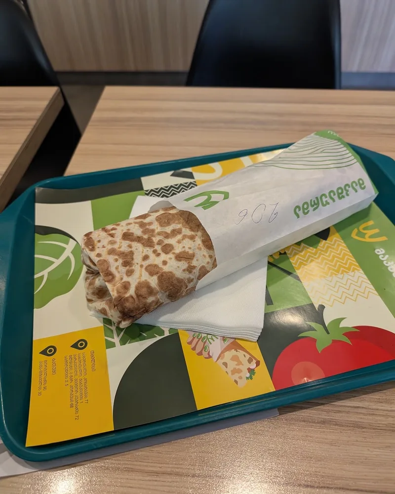 Wrapped shawarma on a paper tray at MacShaurma