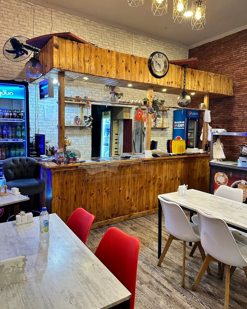 Dining area and wooden service counter at Magical Shawarma