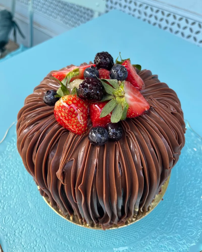 Chocolate cake topped with strawberries and berries at Matasse1822