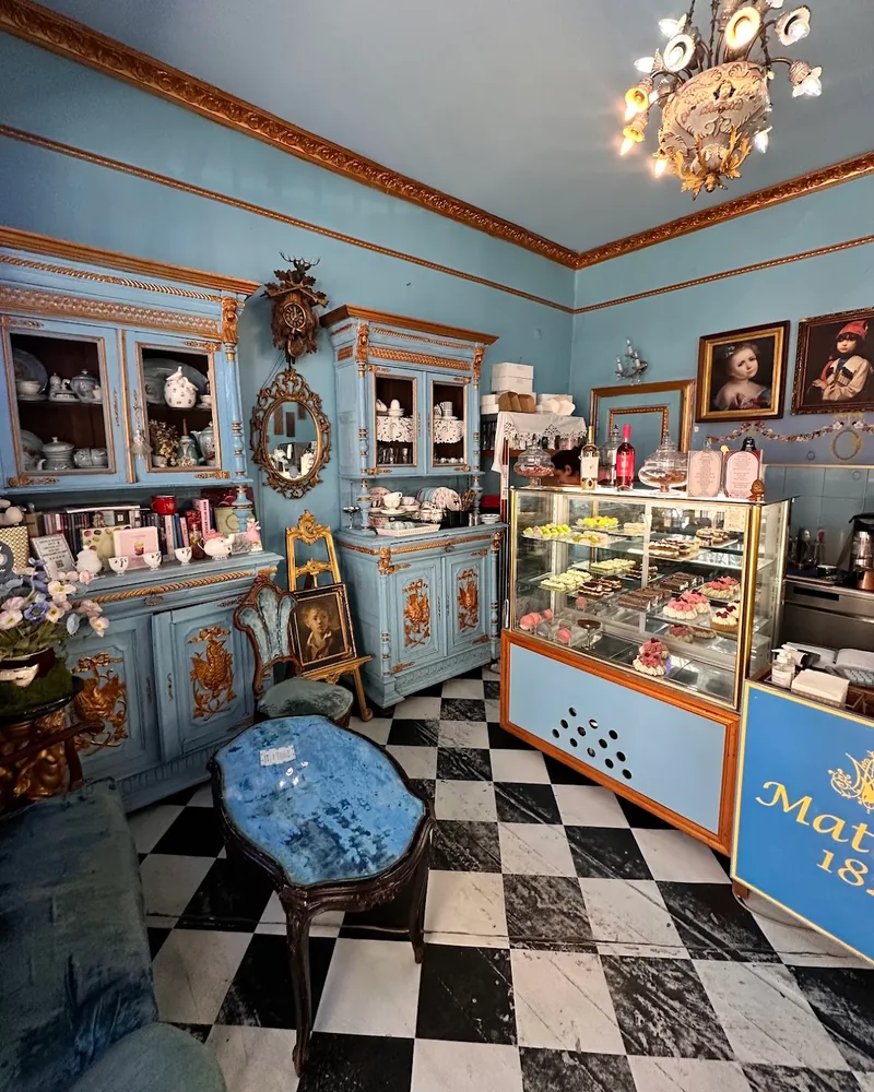Vintage blue parlour interior with a pastry display case at Matasse1822