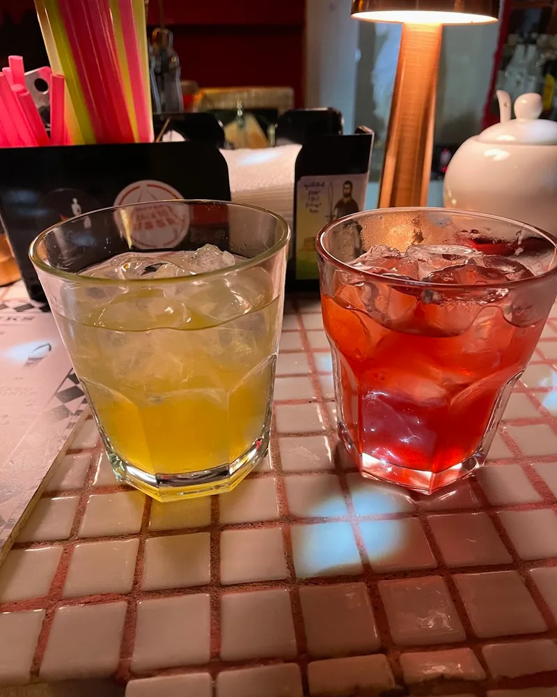 Two iced cocktails in faceted tumbler glasses at Mimosa Bar & Kitchen