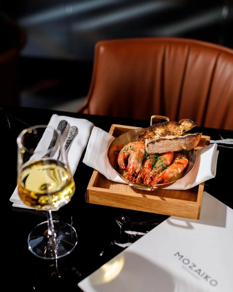 Prawns with toasted bread in a pan at Mozaiko