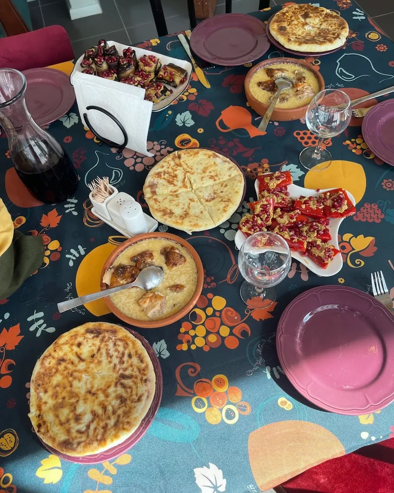 Georgian feast spread with khachapuri, shkmeruli and badrijani nigvzit at Nana's Kitchen Cooking Classes