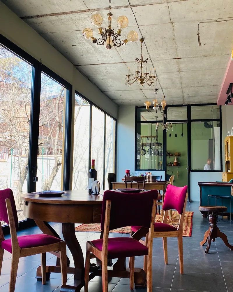Dining space with floor-to-ceiling windows and piano at Nana's Kitchen Cooking Classes
