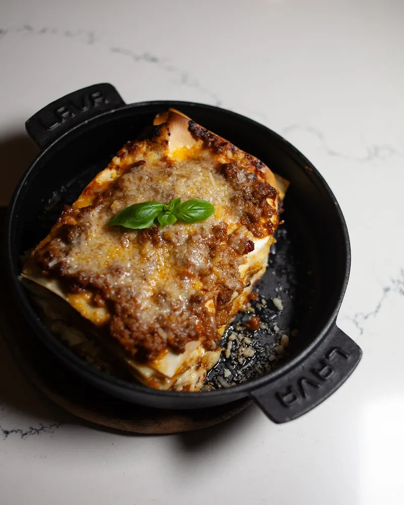 Lasagna in a cast iron skillet at Napoli