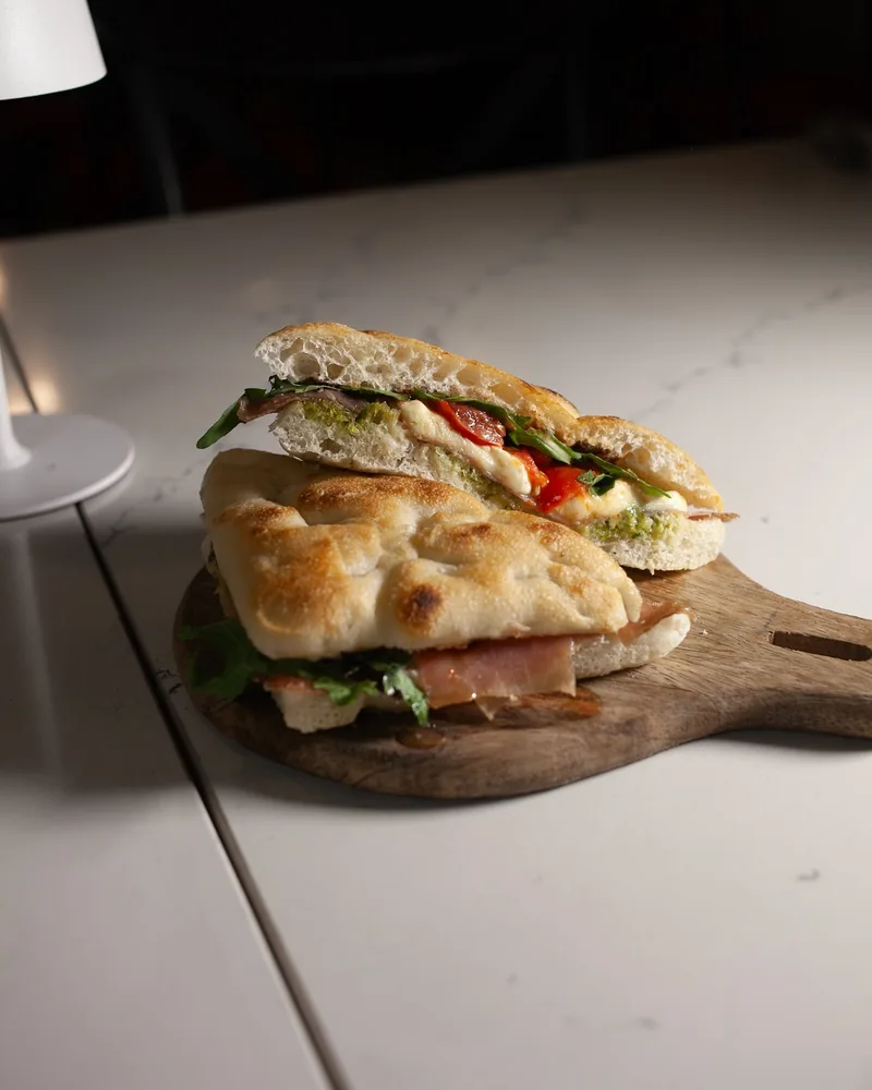 Focaccia sandwich on a wooden serving board at Napoli