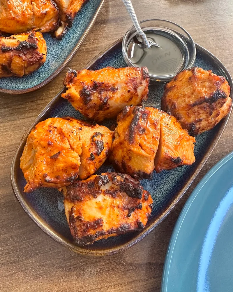 Chicken skewers with dipping sauce on an oval plate at Nikala's Yard