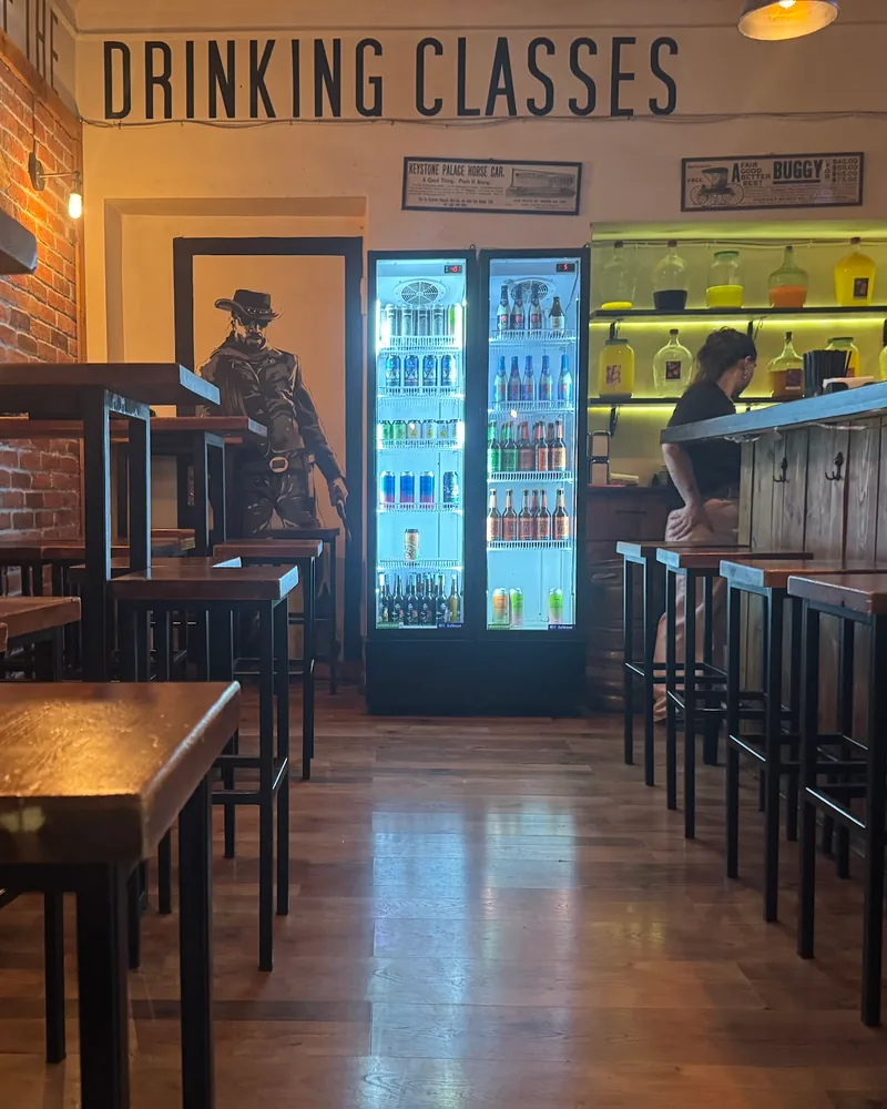 Brick and wood bar interior with high tables and stools at Number 8