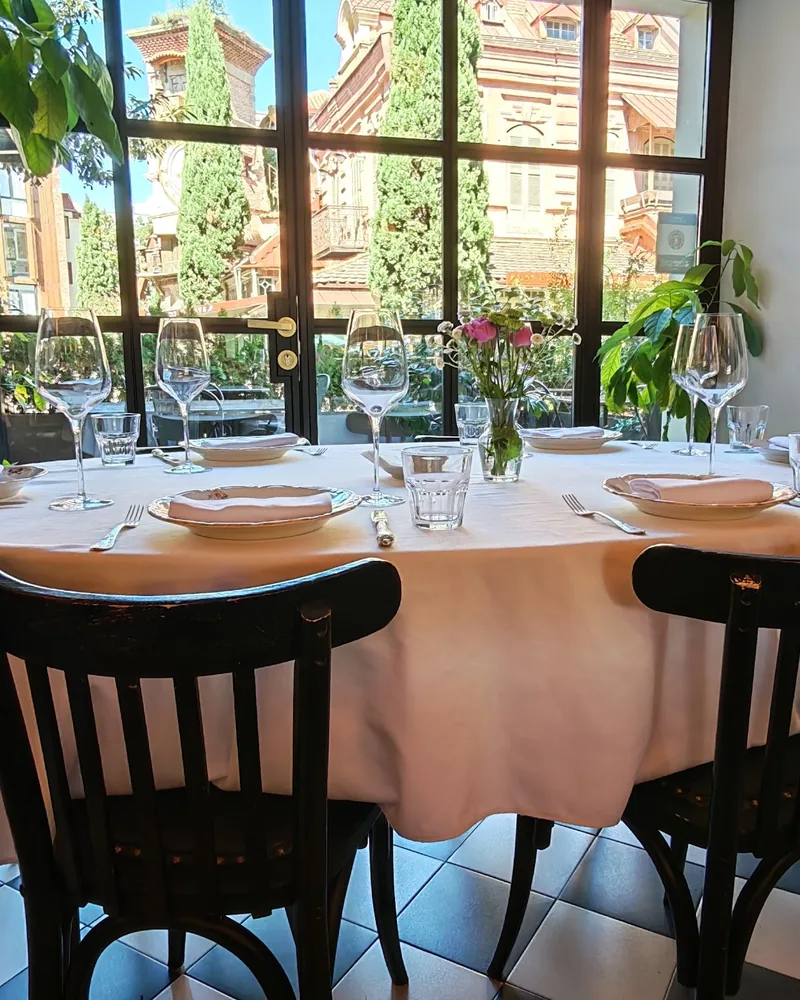 Set dining table with checkered floor and window view at OtsY