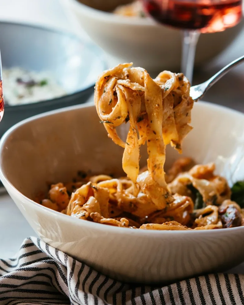 Pasta on a fork lifted from a bowl at Pasta Osteria