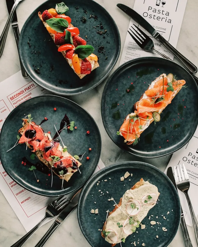 Bruschetta topped with salmon, tomatoes, and pate at Pasta Osteria