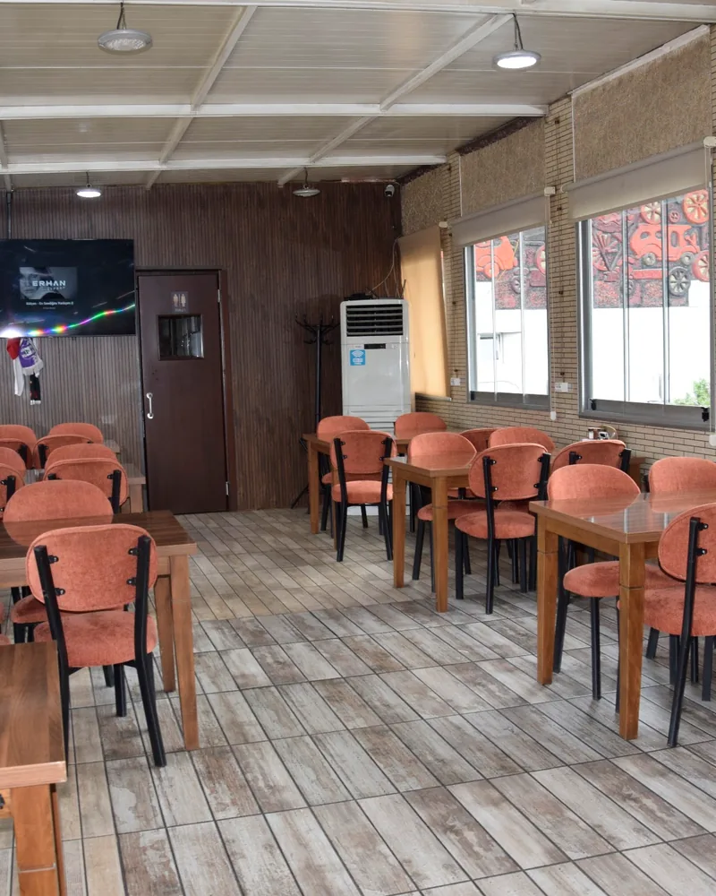 Indoor dining area with tables and orange upholstered chairs at Pide Jimi