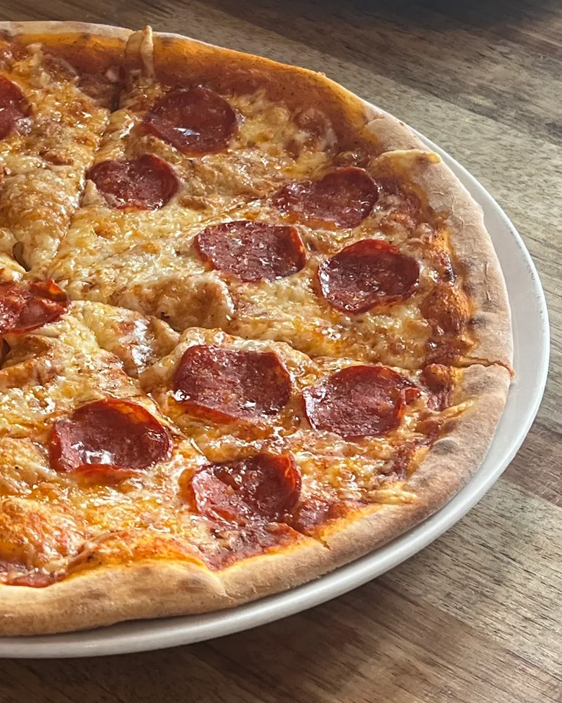 Pepperoni pizza on a white plate at Pizzeria Localino
