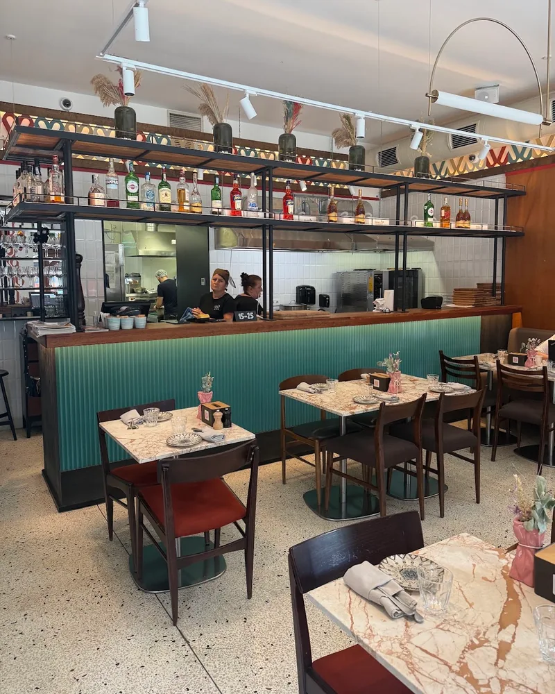 Dining area and bar counter with open kitchen at Pkhali Khinkali