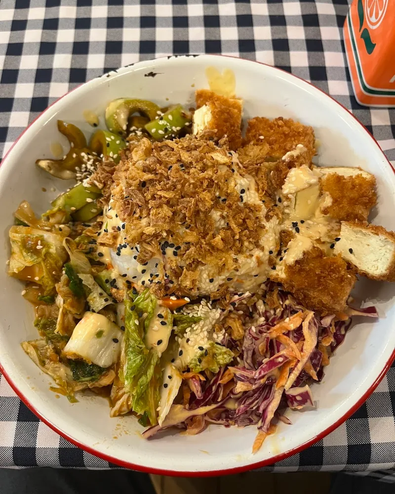 Bowl of crisp fried tofu with kimchi, red cabbage slaw and crispy onions at Plantastic Kitchen