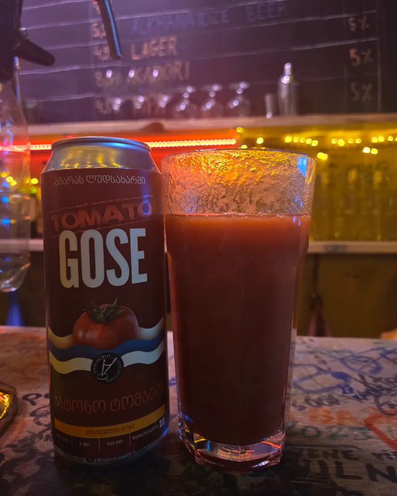 Tomato gose beer in a glass beside its can at Process Craft Beer Bar
