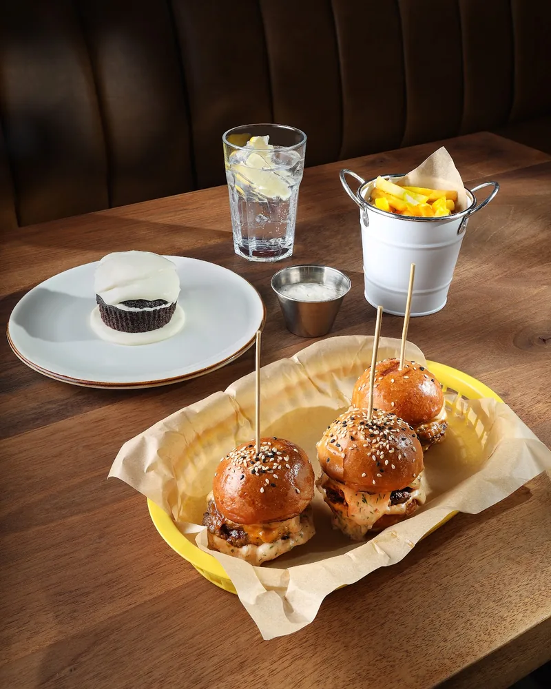 Sliders in a basket with fries and a dessert at Pub 44