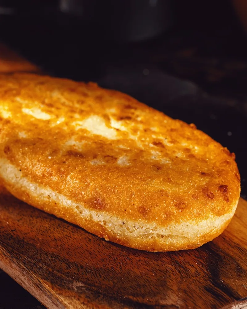 Fried pastry on a wooden board at Pub Georgian
