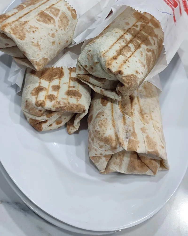 Wrapped shawarmas on an oval platter at Qute's Shaurma