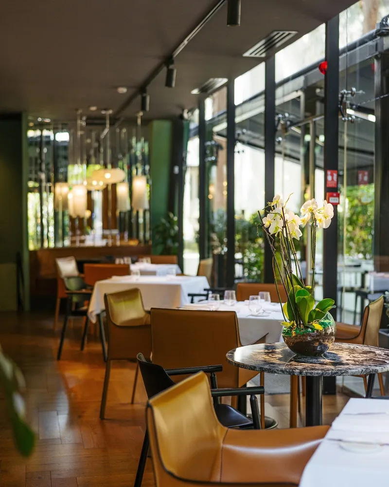 Dining room with floor-to-ceiling windows and orchid centrepiece at Reserve