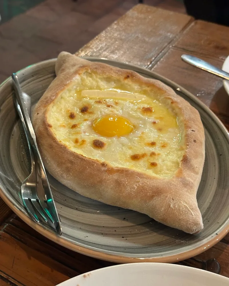 Adjarian khachapuri with egg and butter at Pasanauri (Kazbegi Avenue)