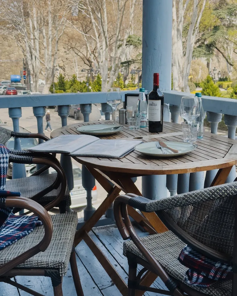 Balcony table setup overlooking the street at Usakhelouri