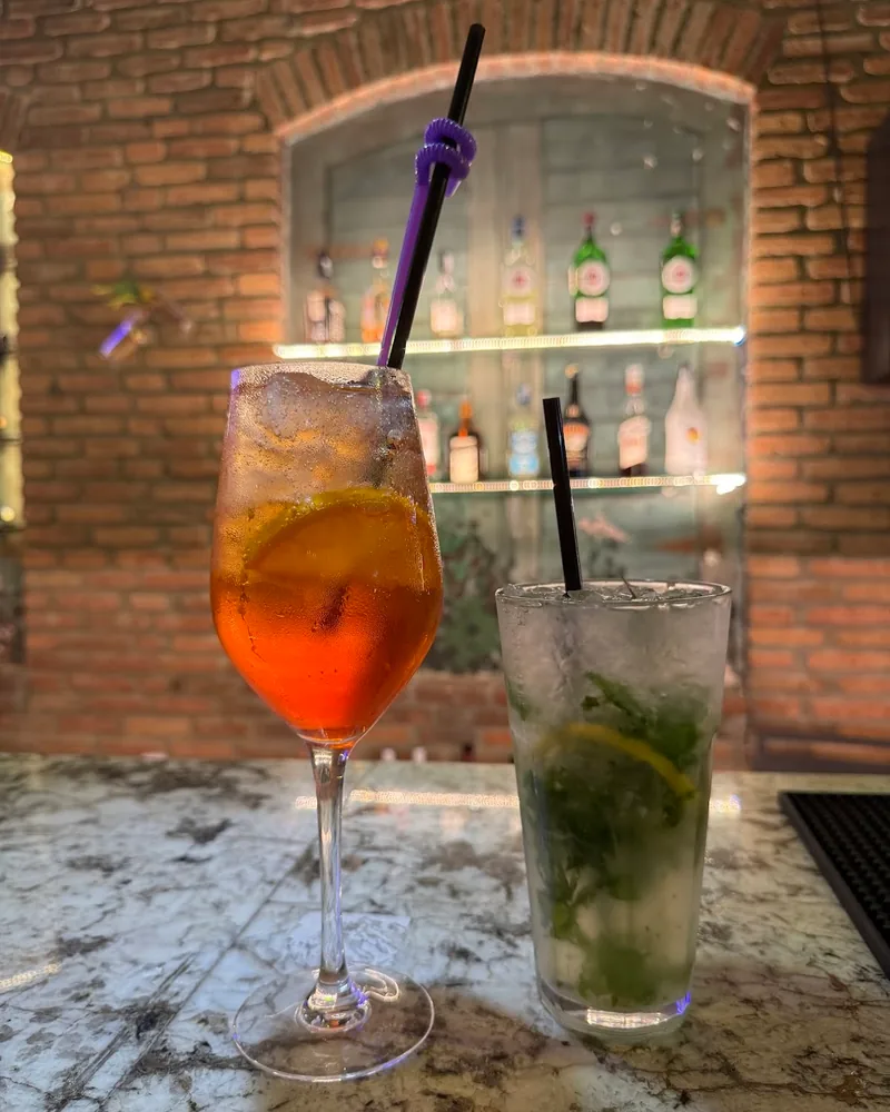 Spritz and mojito cocktails on a marble bar counter at Rezidenco Terrace