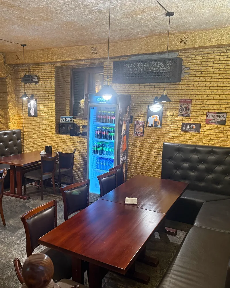 Dining area with brick walls and leather booths at Royal Kitchen Premium