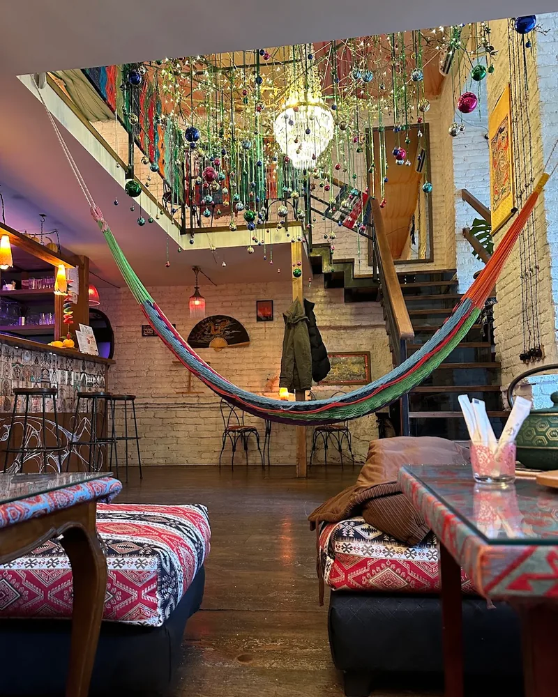 Eclectic lounge with hammock, mezzanine, and low seating at Samsara