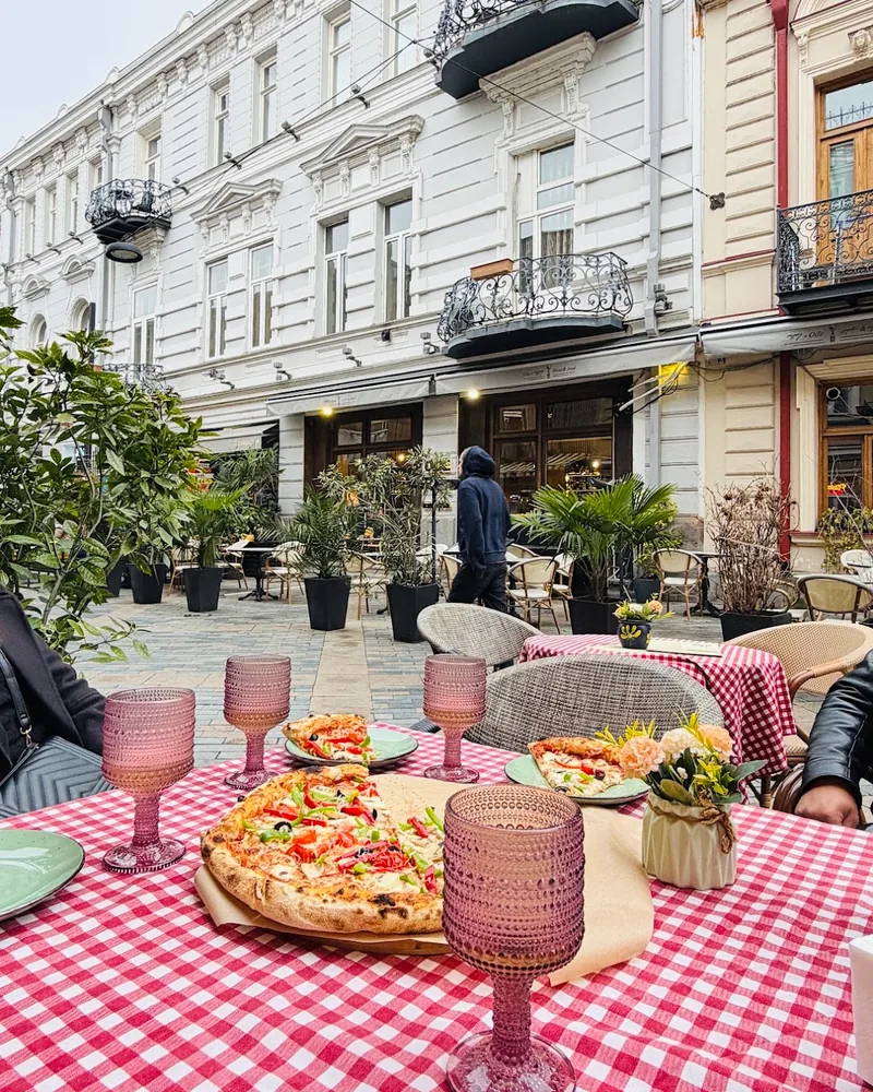 Outdoor patio seating on a pedestrian street at Savora