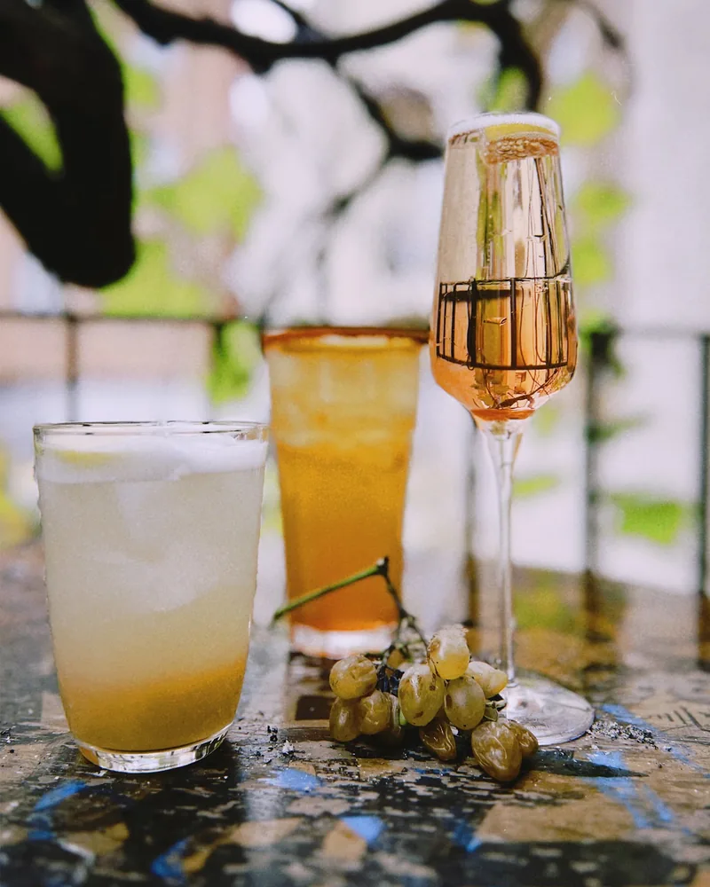 Cocktails and sparkling drink in a flute with grapes at Secret Place