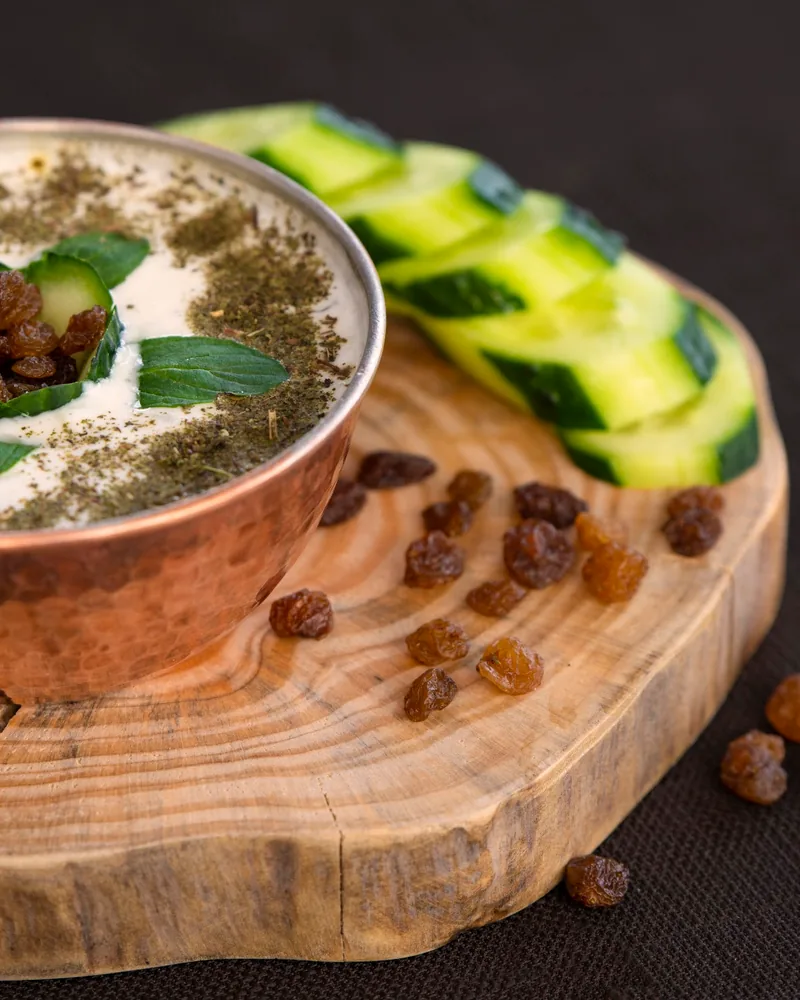 Mast-o khiar in a copper bowl with raisins and herbs at Shandiz