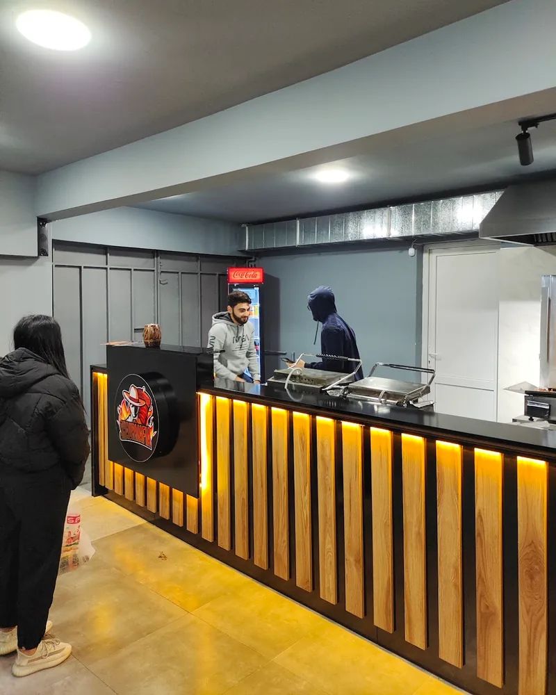 Service counter with back-lit slatted wood paneling at Shaurmafia