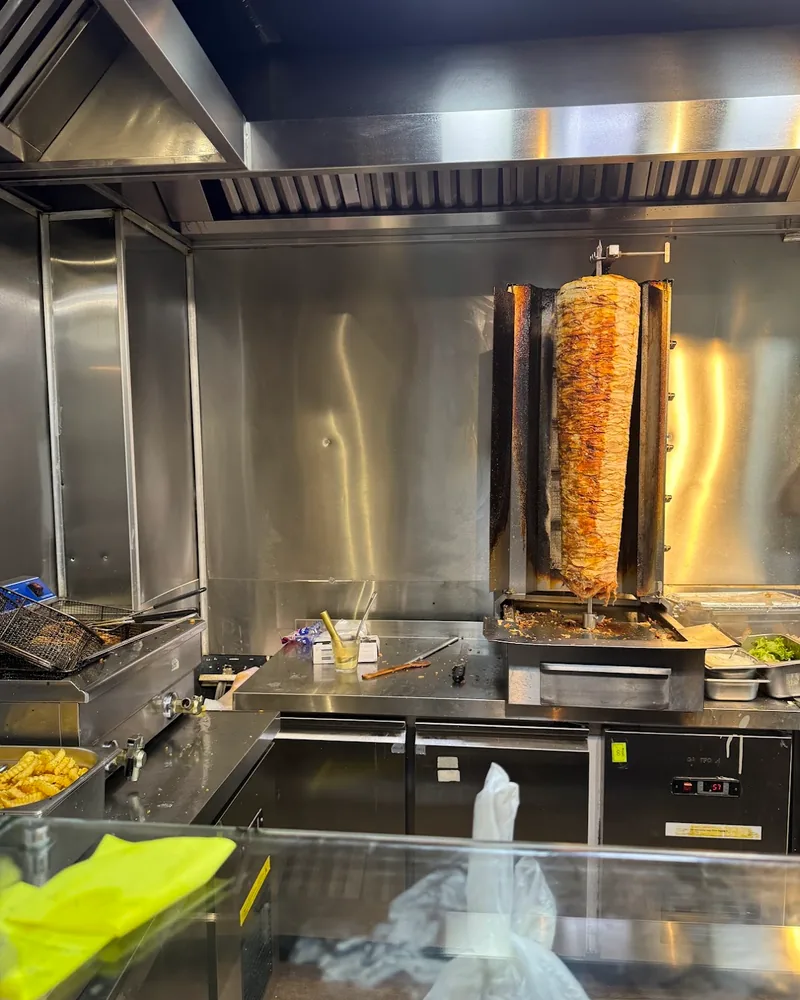 Shawarma spit and kitchen counter at Shawarma Haifa
