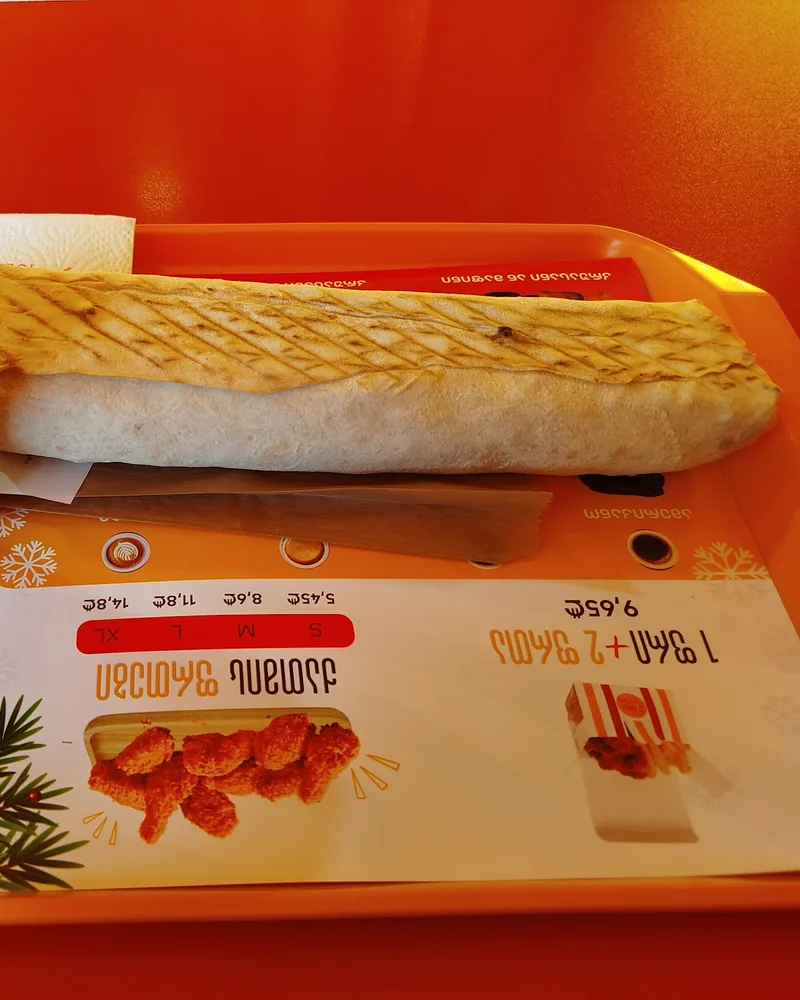 Shawarma roll and cup of ayran on a tray at Shawarma House