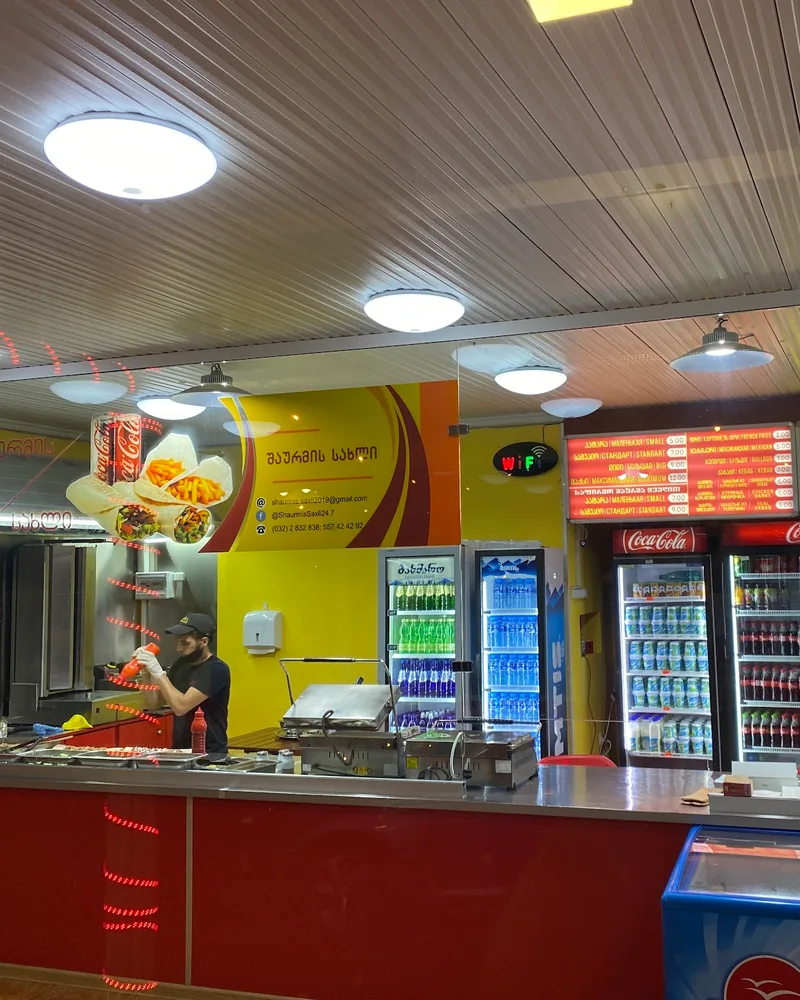 Service and shawarma preparation counter with drinks fridges at Shawarma House