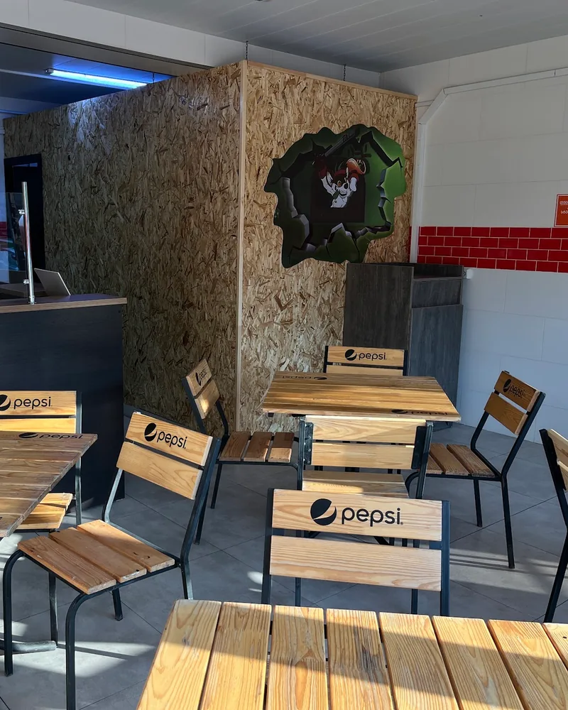 Indoor dining area with wooden tables and chairs at Shawarmaniac