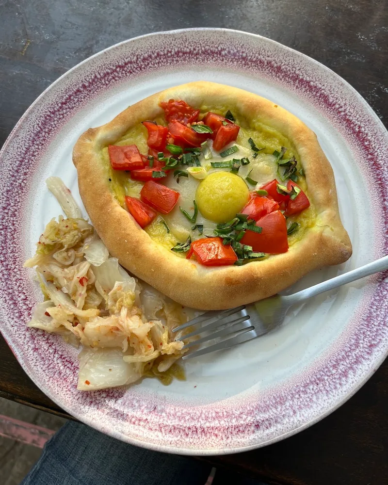 Khachapuri with egg and chopped tomatoes at Shpana
