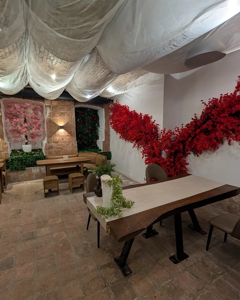 Dining room with draped fabric ceiling and floral wall decor at Siam Thai Cuisine