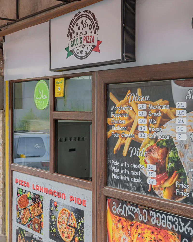 Storefront of Silo's Pizza with menu windows at Silo's Pizza & More