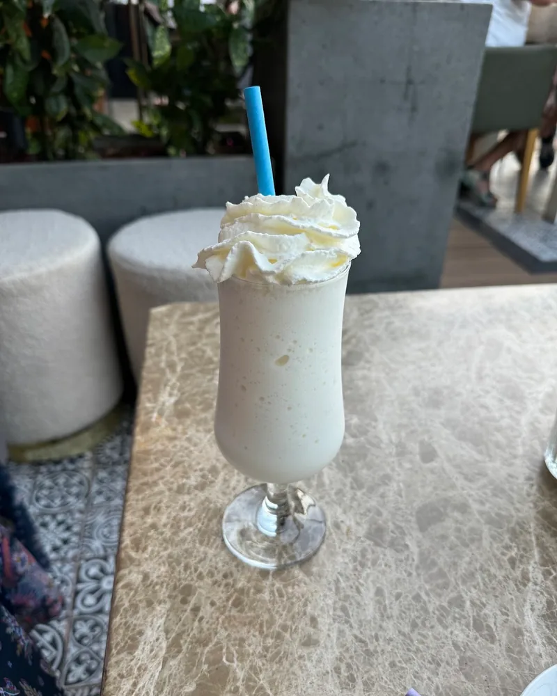 Milkshake with whipped cream and a blue straw at Sky7 Terrace & Lounge Bar