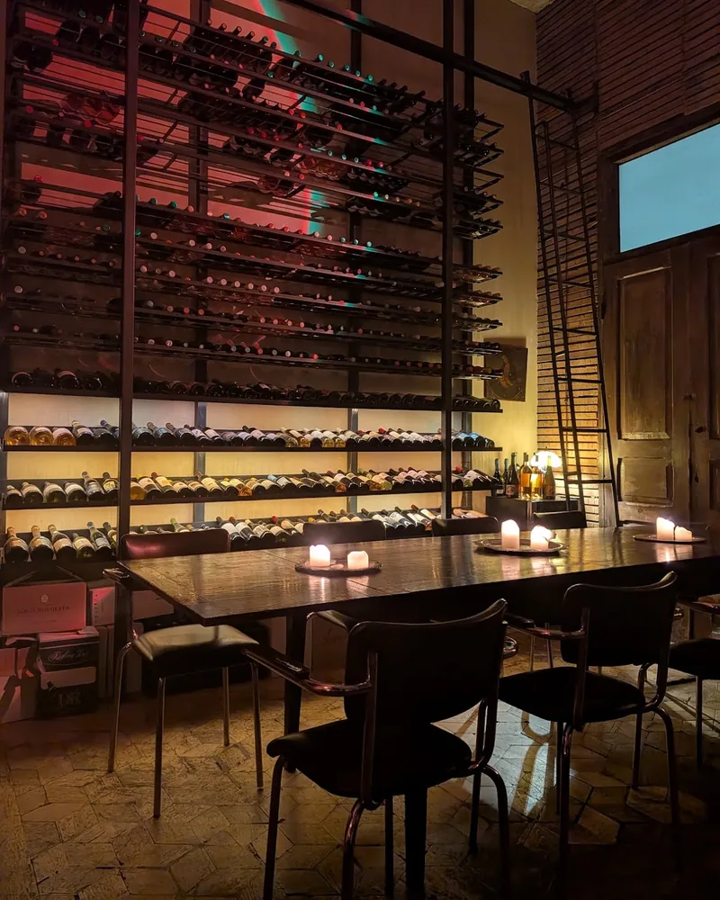 Candlelit table beside a wine rack at Snobs