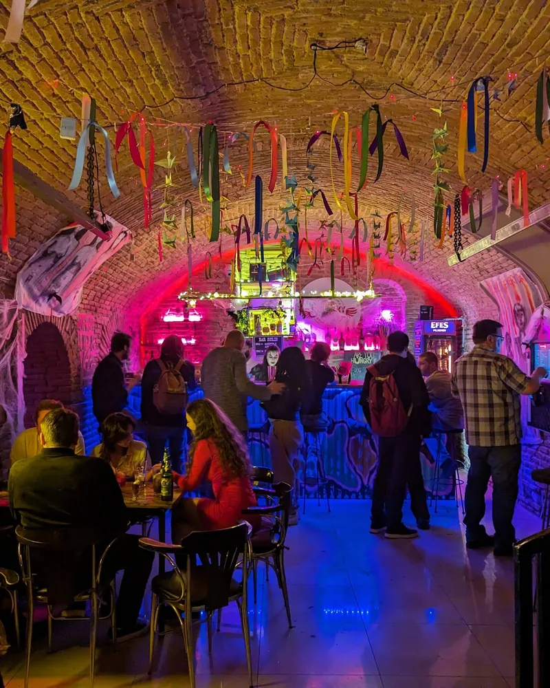 Brick-vaulted bar cellar with colourful ribbons and neon lights at So Lucky Cocktail Bar