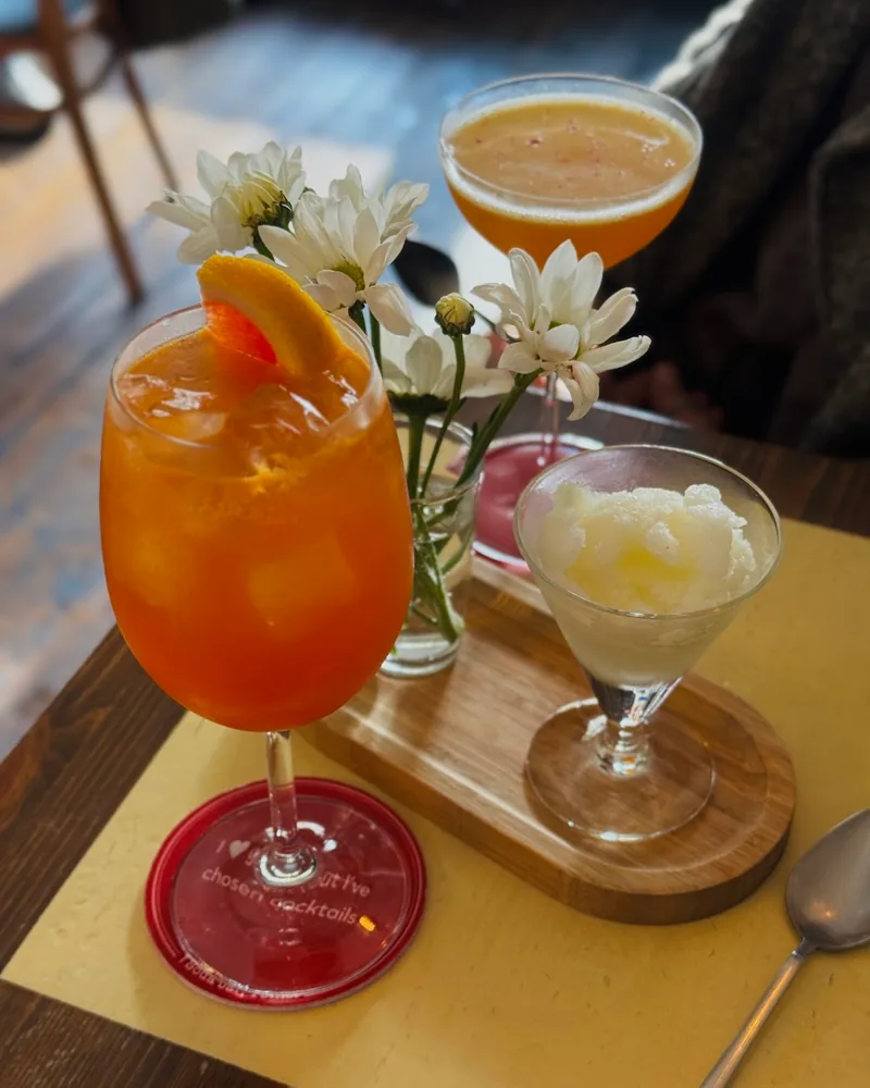 Spritz cocktail with an orange slice and sorbet alongside at Soda