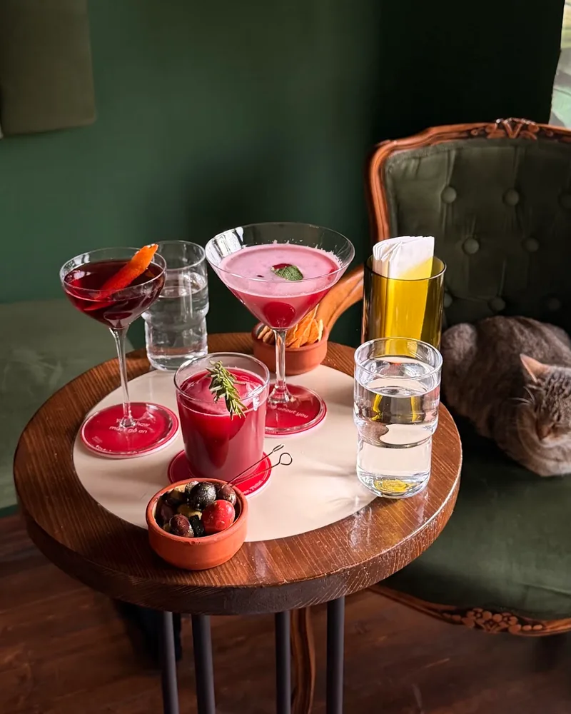 Cocktails and olives on a round table at Soda