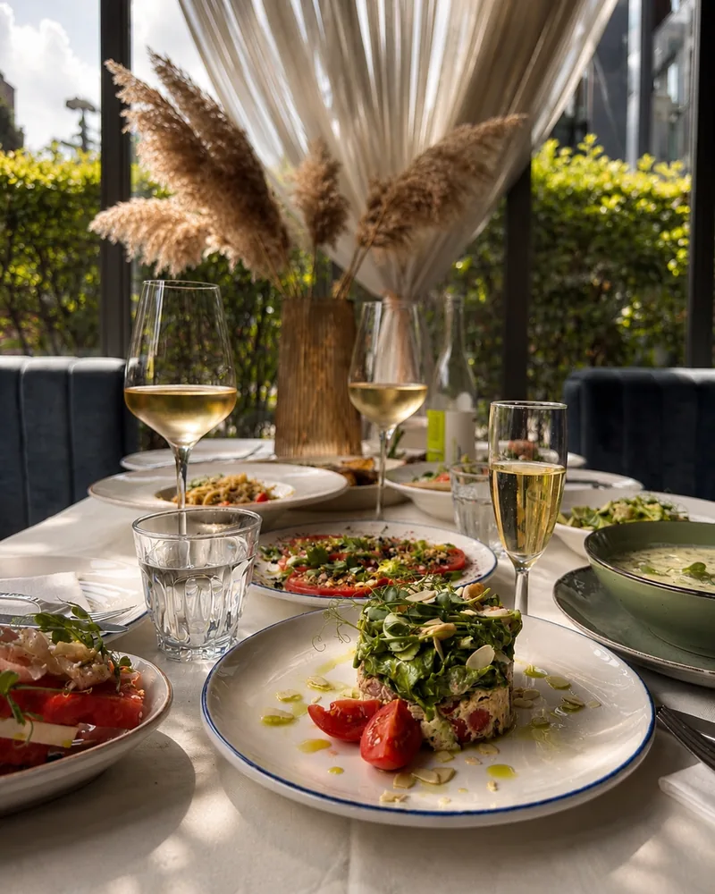 Tartare with microgreens and white wine on a set dining table at St.Bunny